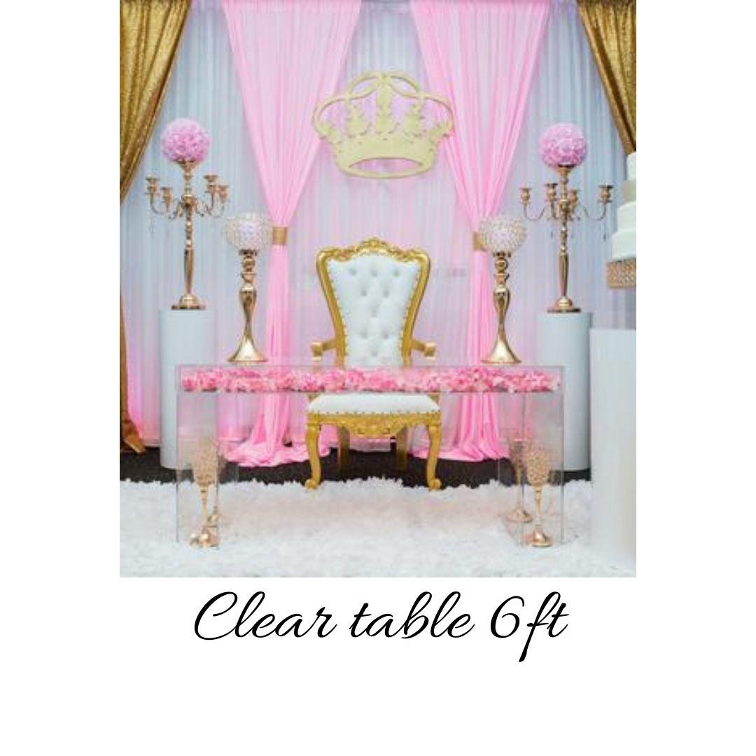 A table with two chairs and a pink curtain