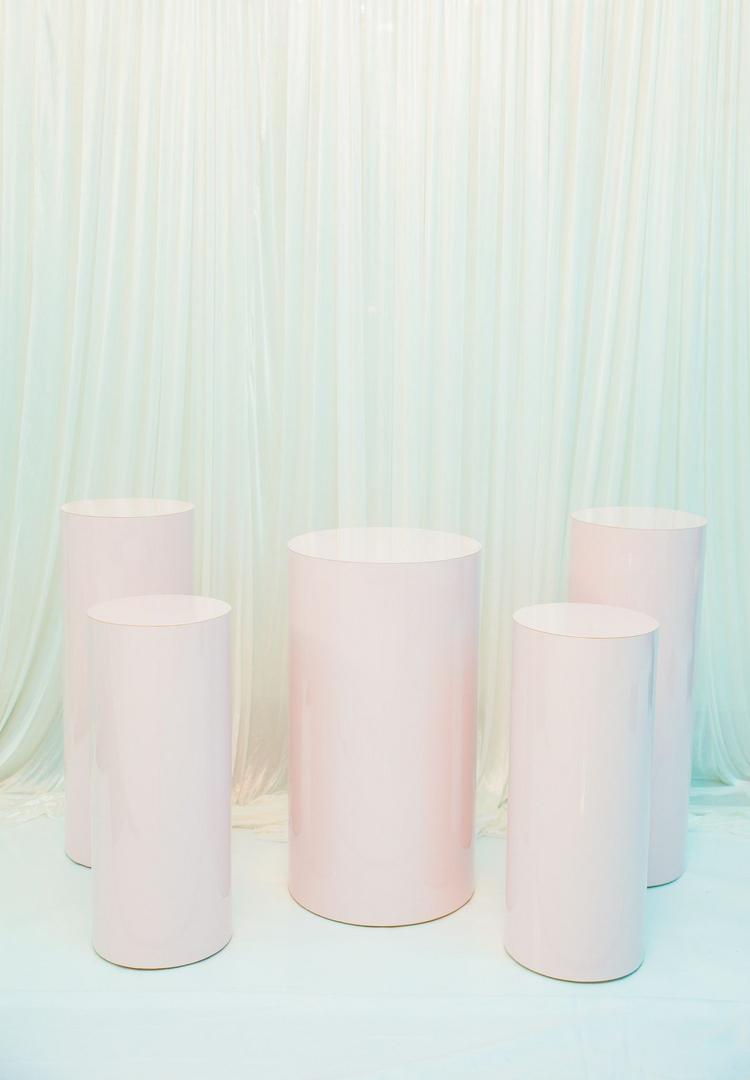 A group of pink cylinders sitting on top of each other.