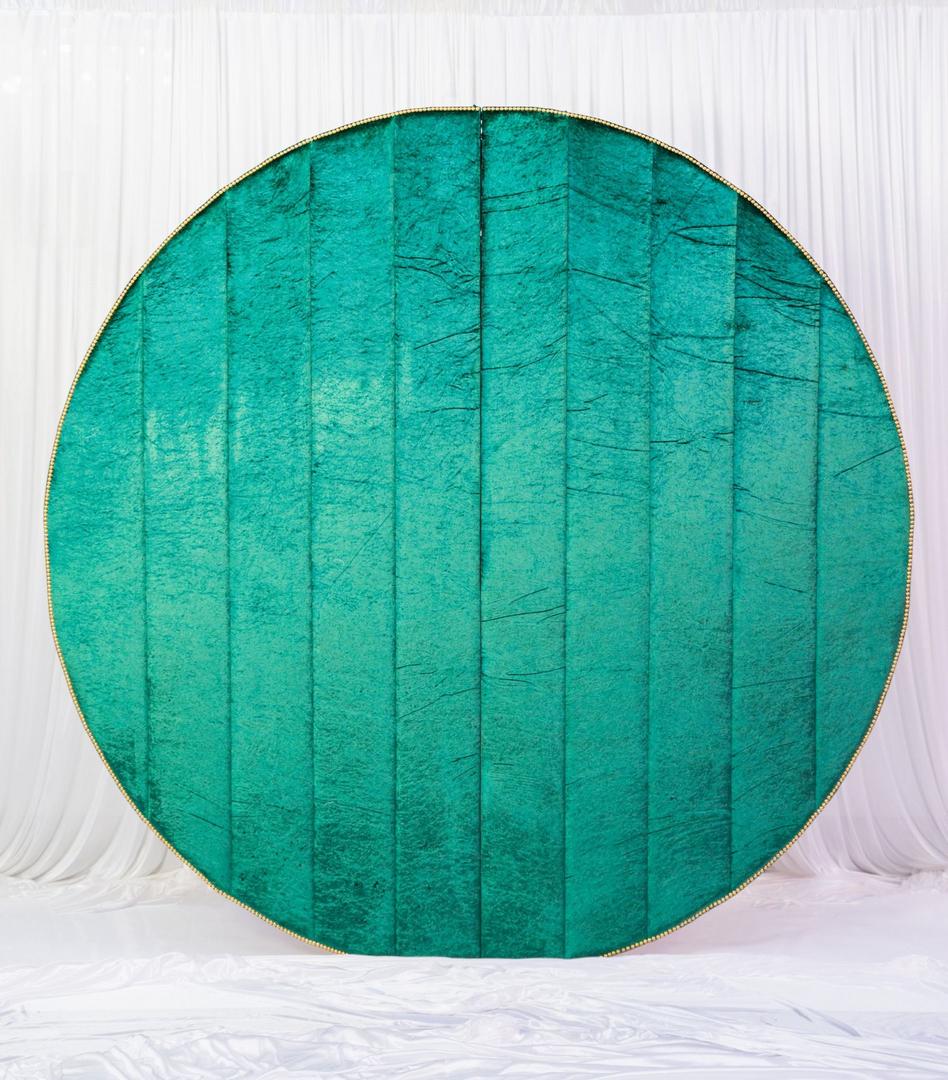 A round green backdrop with a white background.