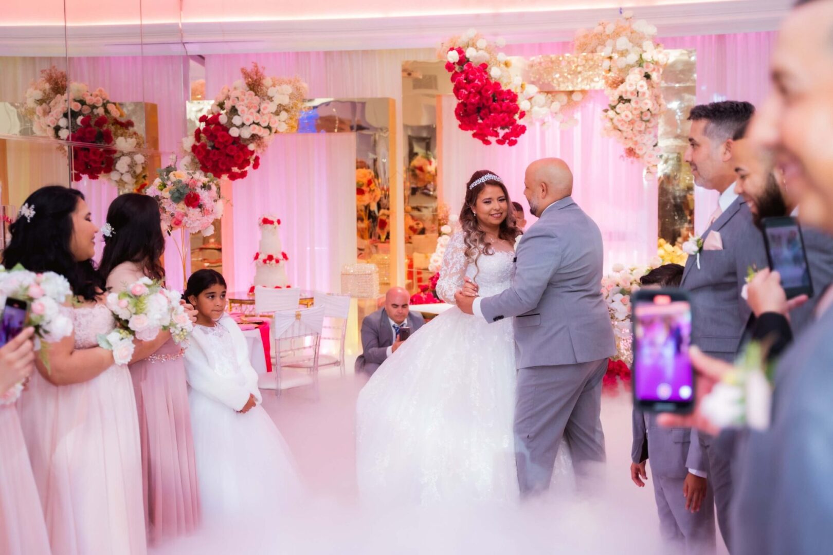 A couple dancing in front of a group of people.