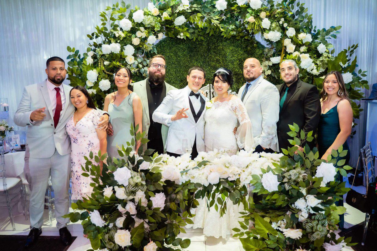 A group of people standing around a table.