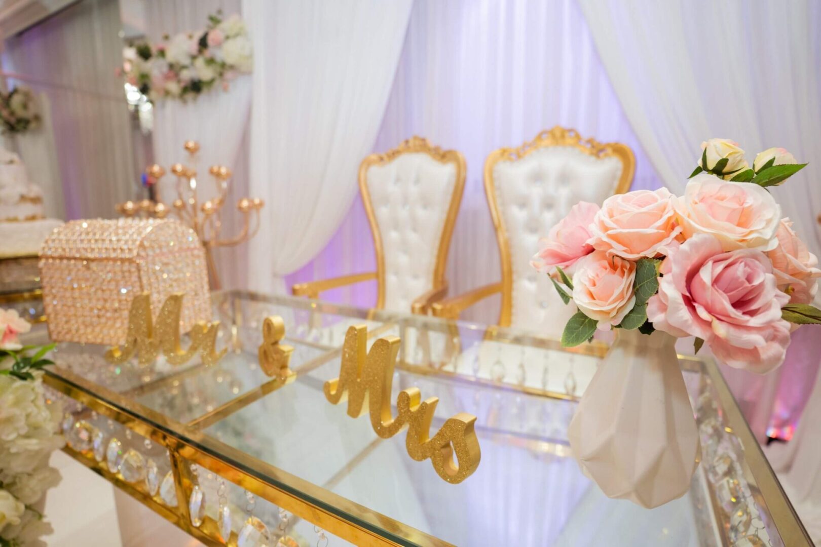 A table with two chairs and flowers on it