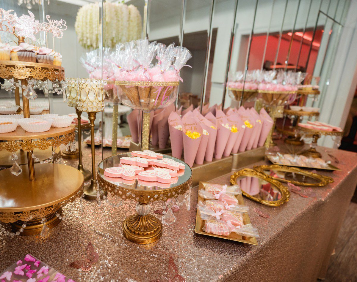 A table filled with lots of pink desserts.