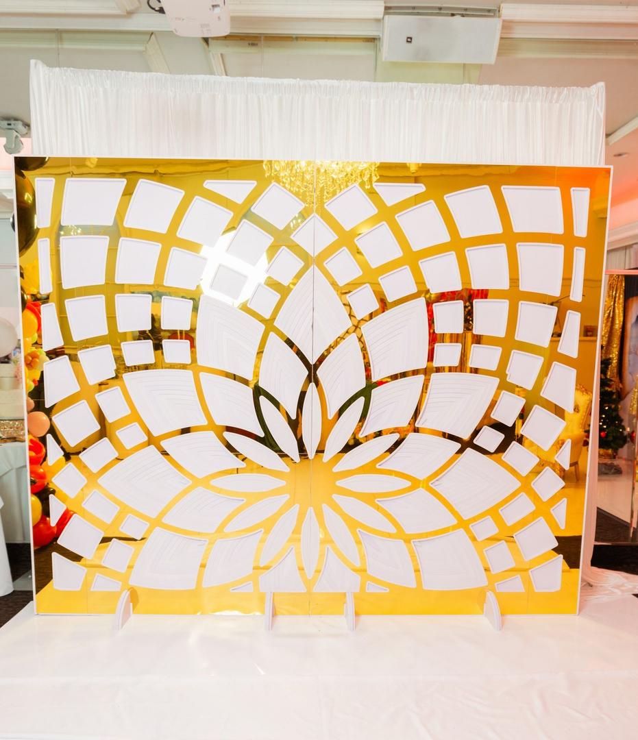 A gold and white screen with a flower design.