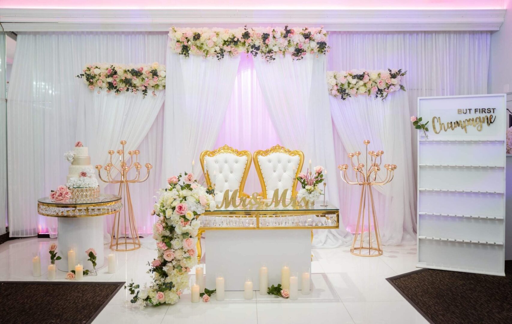 A wedding set up with white and gold decor.