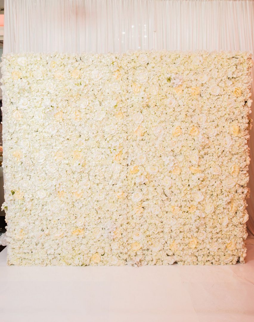 A white flower wall with many flowers on it