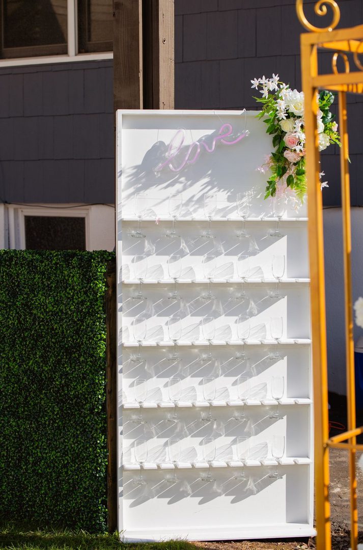 A white display case with flowers on top of it.